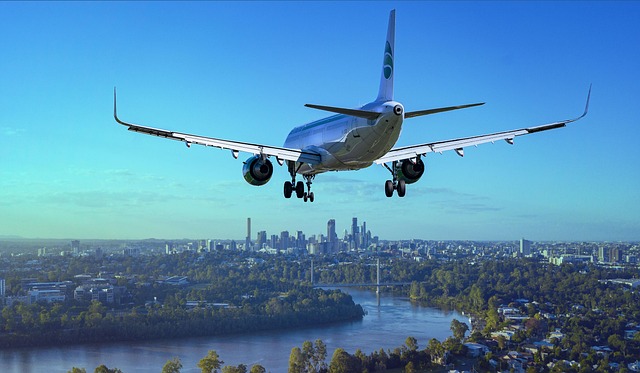 airplane, flight, city, landing, river, boeing, aircraft, plane, travel, flying, sky, nature, passenger aircraft, airliner, aviation, arrival, transport, skyscrapers, urban
