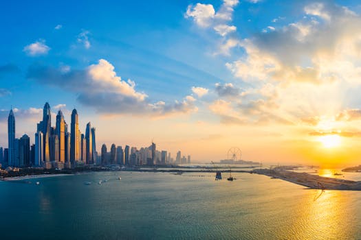 Stunning view of Dubai's skyline and waterfront during golden hour with glowing skyscrapers reflecting on the water.